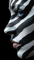 Striking black and white face paint design showcasing a dramatic zebra pattern during a creative art session photo