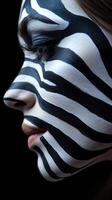 Creative makeup artistry showcasing zebra stripes on a woman's face with a dark background photo