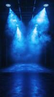 Blue fog and spotlight beams create a dramatic atmosphere in an empty venue photo