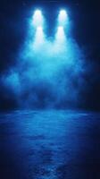 Moody stage lighting creates an atmospheric setting with blue fog illuminating the performance space at night photo