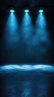 Bright blue spotlights illuminate a darkened stage, creating a dramatic atmosphere for performances and events photo