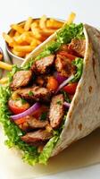 Delicious wrap filled with grilled meat, fresh vegetables, and fries served in a casual dining setting photo