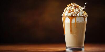 Delicious creamy dessert drink topped with caramel syrup and whipped cream served in a tall glass on a wooden table at a cozy cafe photo