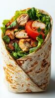 Delicious chicken wrap filled with fresh vegetables and herbs served on a white background photo