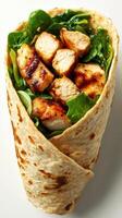 Grilled chicken wrap with fresh spinach and herbs at a dining table photo