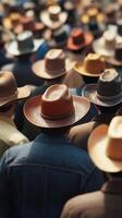 Crowded outdoor event featuring numerous individuals wearing cowboy hats during a sunny daytime gathering photo