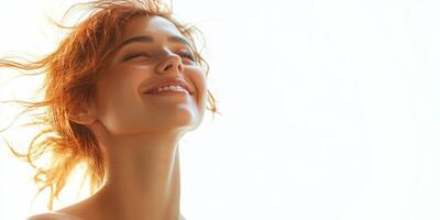 Joyful young woman enjoying a moment of serenity and happiness with sunlight shining on her face photo