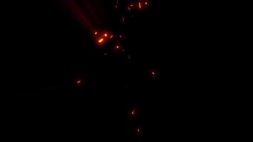Bright embers of fiery sparks swirl and dart in space, like fireflies in the night. video