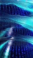 A looped blue background of sparkling smooth waves flowing smoothly into each other. video