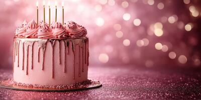 Beautiful pink birthday cake with candles and sparkling background perfect for celebrations and special occasions photo