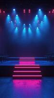 Brightly lit stage with colorful lights prepares for a dramatic performance in an empty theater setting at night photo