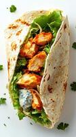 Grilled chicken wrap filled with fresh lettuce and creamy dressing served on a crisp tortilla photo