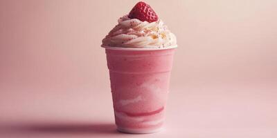 Delicious strawberry milkshake topped with whipped cream and fresh strawberry in a cup on a pastel background photo