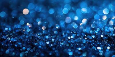 Shimmering blue bokeh effect created by light reflecting off tiny particles during a nighttime setting photo