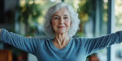 Older woman enjoys a moment of tranquility with arms outstretched in a sunlit room photo