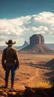 Cowboy gazes at vast desert landscape with iconic rock formations under a dramatic sky photo