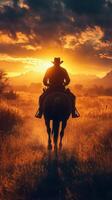 Cowboy riding into the sunset on a horse with vibrant colors filling the sky in the background photo