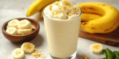 Creamy banana smoothie with oats and fresh bananas on a kitchen counter photo