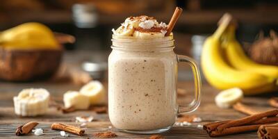 Delicious banana cinnamon smoothie served in a mason jar on a wooden table with fresh ingredients and spices nearby photo