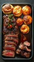 Delicious roasted beef with perfectly baked biscuits served on a black tray photo