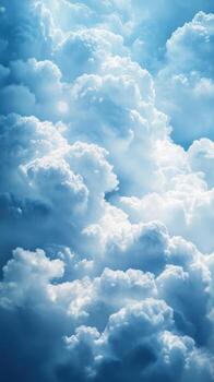 Fluffy white clouds illuminated by sunlight in a bright blue sky creating a serene atmosphere photo