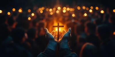 People gather in a solemn vigil holding candles and a cross during an evening ceremony reflecting faith and community spirit photo