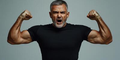 Strong man demonstrating power and confidence in a studio environment photo