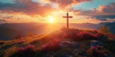 Sunset view with a cross on a mountain top surrounded by blooming flowers photo