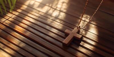 Wooden cross pendant rests on a sunlit wooden surface with soft shadows creating a serene atmosphere photo
