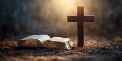 Cross and open Bible resting on a textured surface with light illuminating the background in a serene, spiritual setting photo