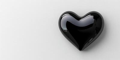 Heart-shaped black object resting on a smooth surface, creating a striking contrast in a minimalist setting photo