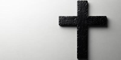Black wooden cross displayed against a light background in a serene setting for reflection and meditation photo