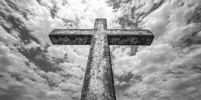 Stone cross stands tall against a cloudy sky in a solemn setting conveying reverence and memory photo
