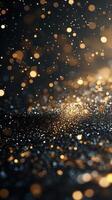 Bright golden and silver particles shimmer against a dark background in a captivating display of light and texture photo