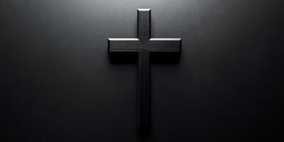 Elegant black wooden cross displayed against a dark background highlighting its simple beauty and significance in spirituality photo