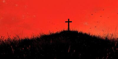 Dark silhouette of a cross against a vivid red sky during twilight over a grassy hill photo