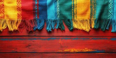 Colorful textiles displayed on a rustic wooden surface evoke traditional craftsmanship and vibrant culture photo