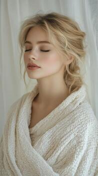Softly lit portrait of a woman in a cozy shawl exuding tranquility in an intimate setting photo