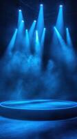 Bright blue stage lights illuminating a circular platform in a hazy space set for a performance photo