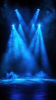 Bright blue stage lights illuminate a dramatic performance space filled with fog and anticipation before the show starts photo