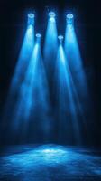 Bright blue stage lights create a dramatic atmosphere for a performance in an empty theater photo