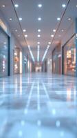 Modern shopping mall corridor features bright lights and polished floor, creating a clean and inviting atmosphere during evening hours photo