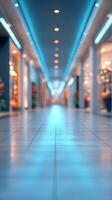 Brightly lit shopping mall corridor with modern design and soft reflections on the polished floor photo