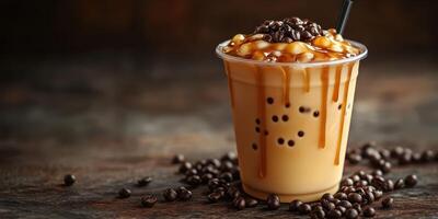 Iced coffee drink with caramel drizzle and coffee beans on a dark wooden surface photo