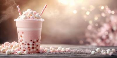 Refreshing pink bubble tea topped with marshmallows served in a clear cup on a wooden table photo