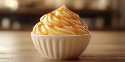 Creamy dessert topped with rich caramel sauce served in a small bowl on a wooden table photo