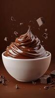 Dark chocolate mousse topped with chocolate shavings in a white bowl against a rich brown backdrop photo