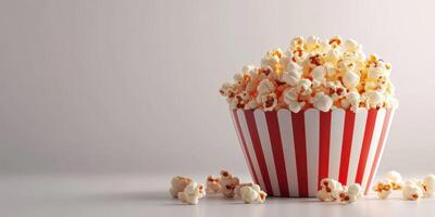 Delicious popcorn in a striped container ready for movie night at home or cinema photo