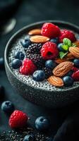 Delicious chia seed pudding topped with fresh berries and almonds in a dark setting photo