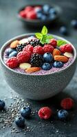 Fresh fruit and nuts topped smoothie bowl served with a colorful array of berries and almonds on a dark background photo